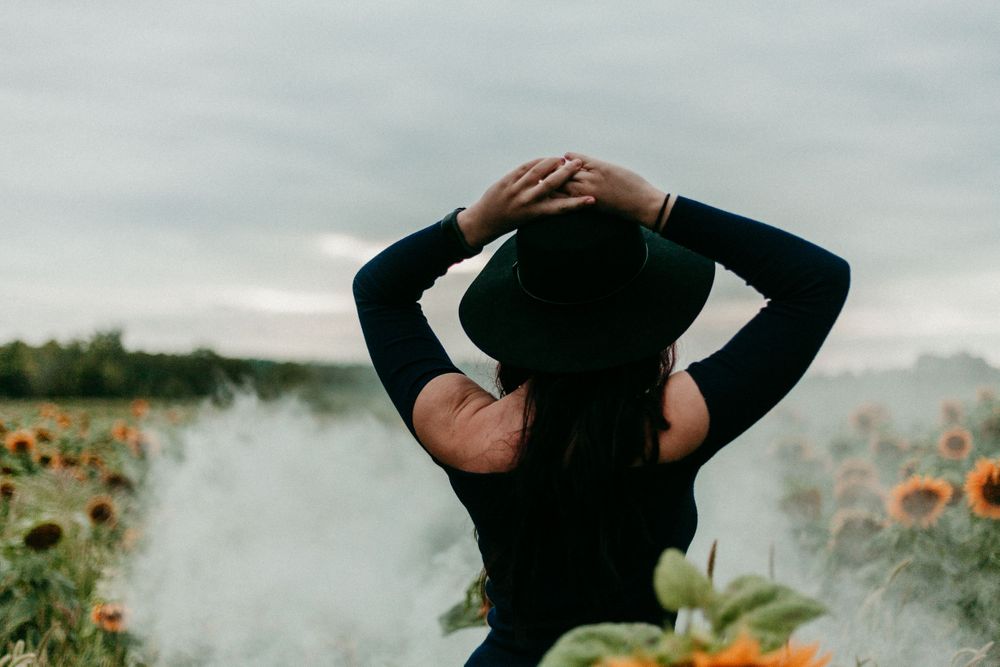 model poses in sunflower field