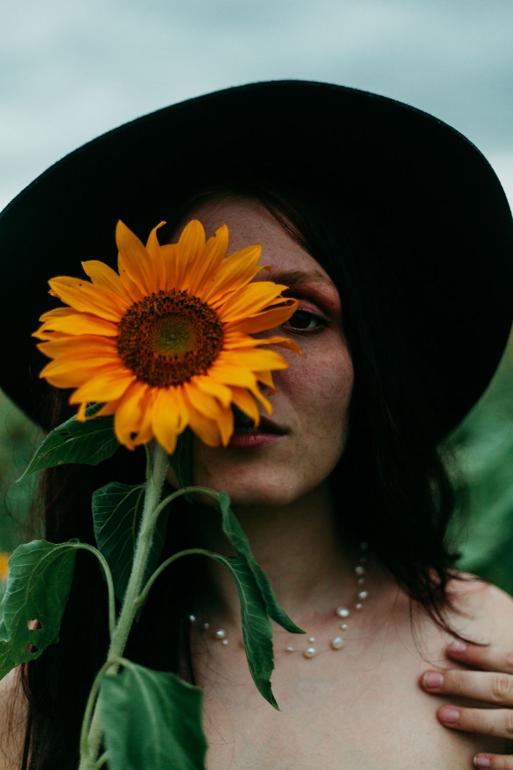 model poses with sunflower