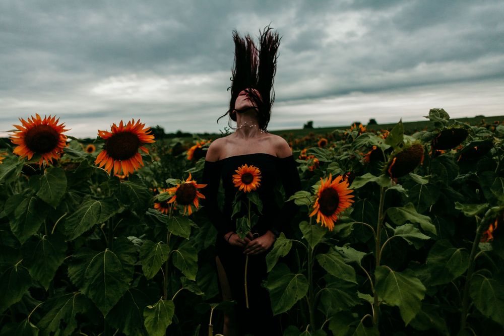 model poses in sunflower field