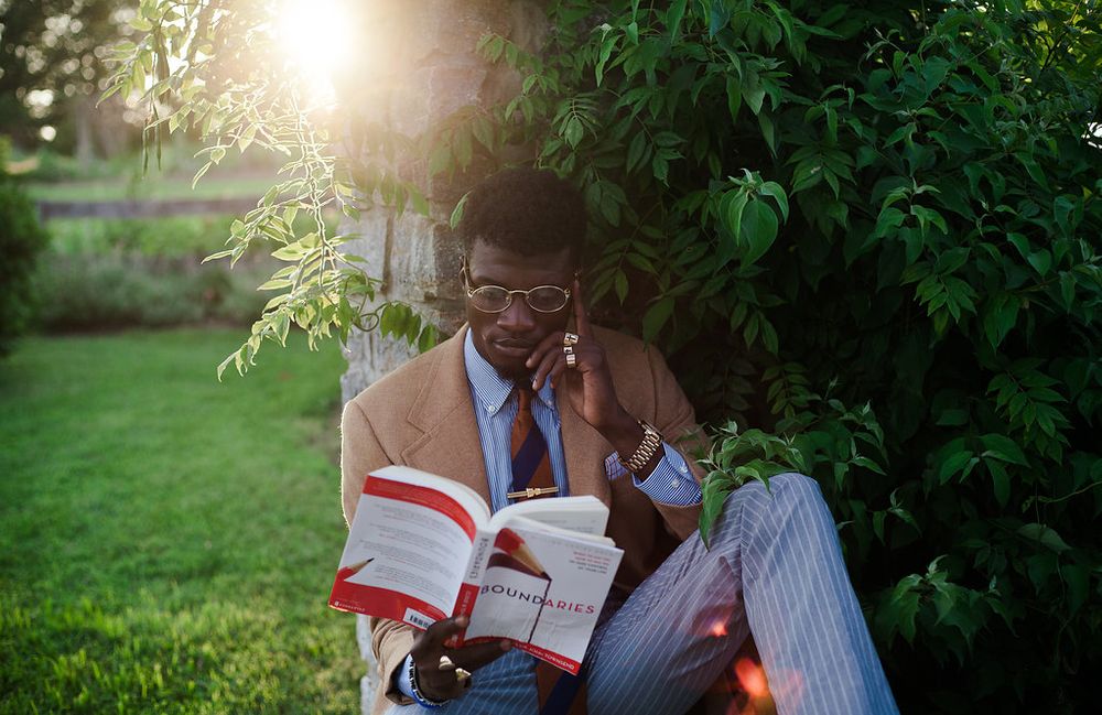 model poses with book