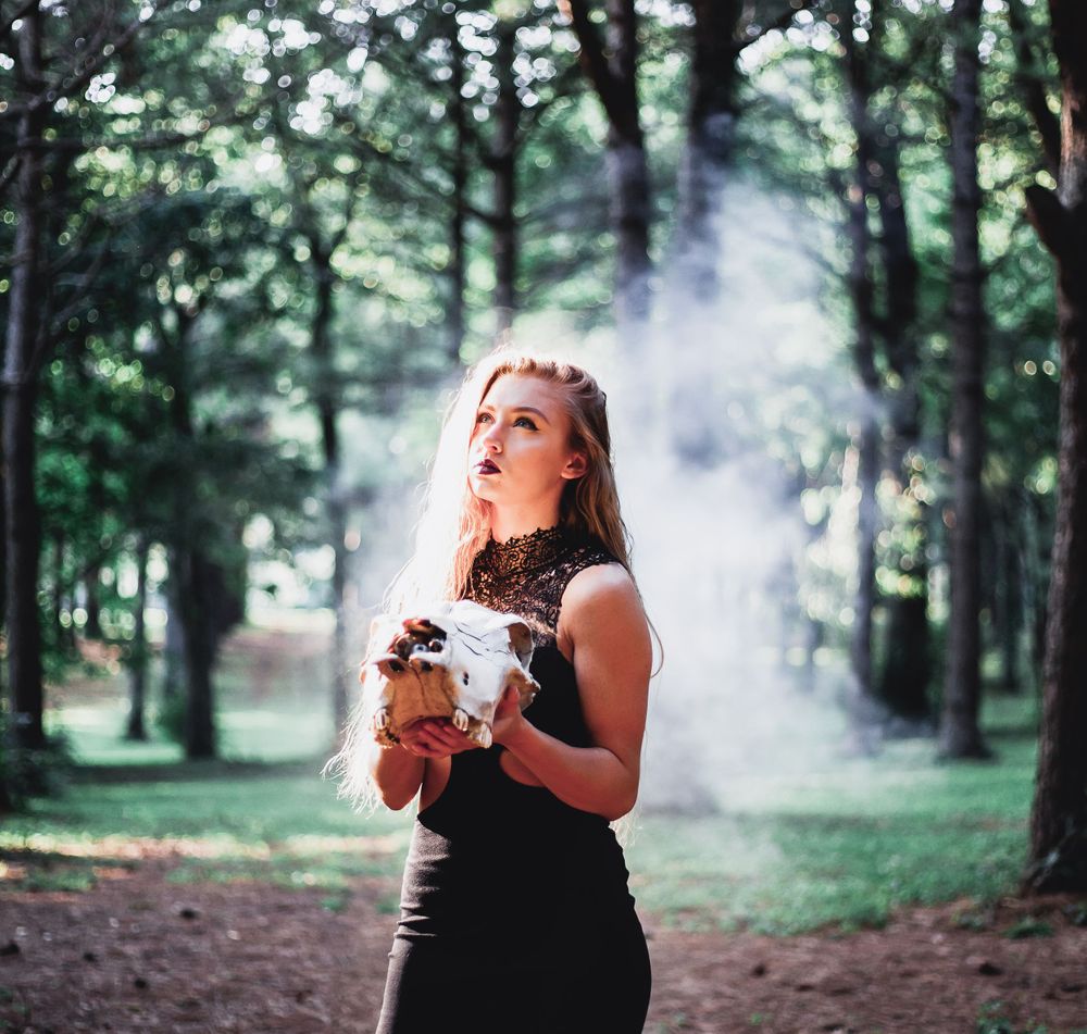 model poses holding skull