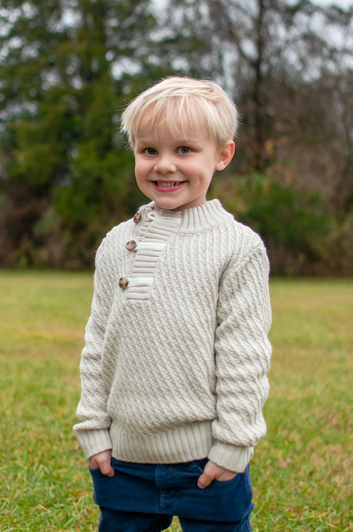 Young child standing with hands in pocket