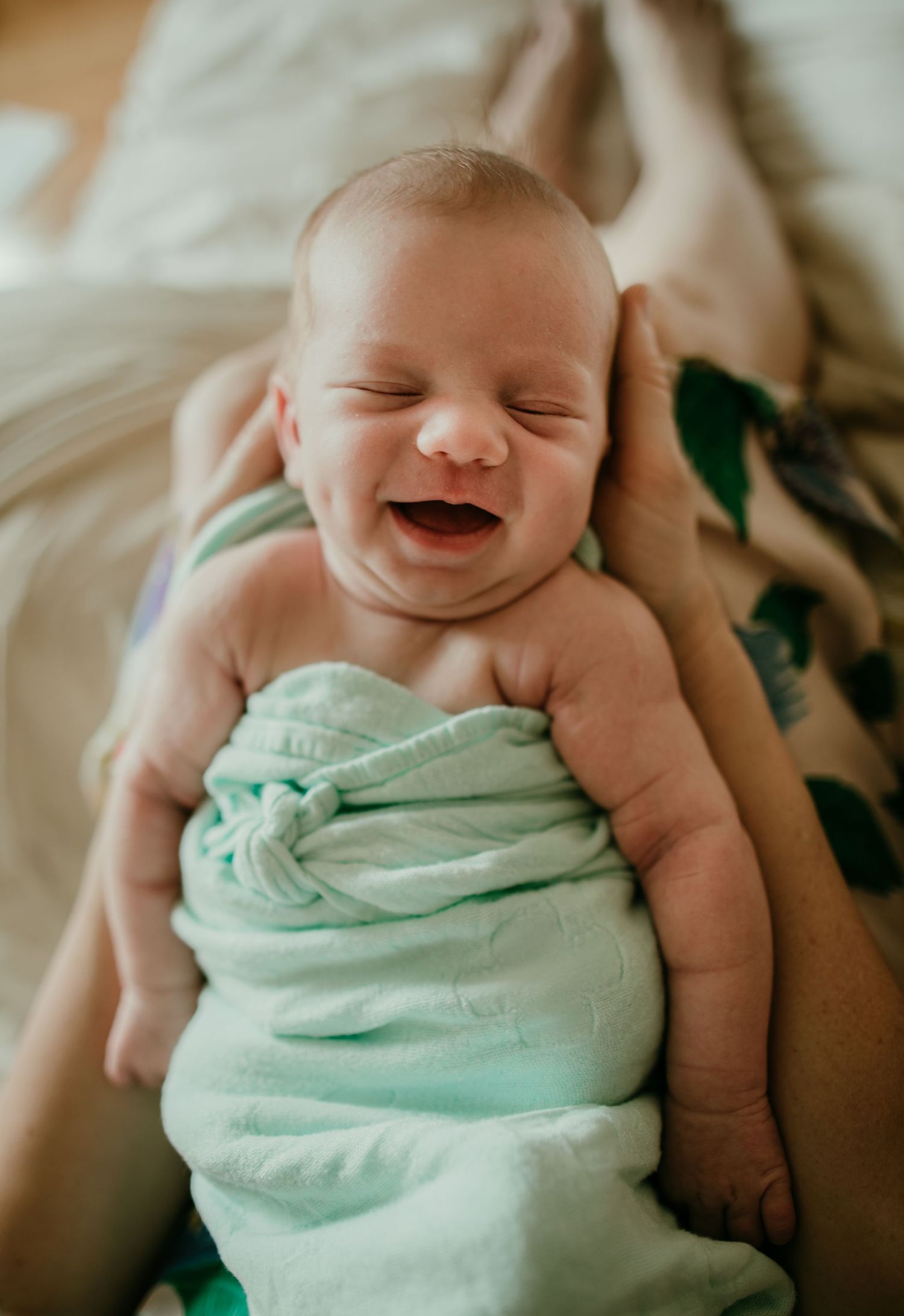 newborn smiles in sleep in mothers arms birth photographer portland oregon maternity newborn family photography