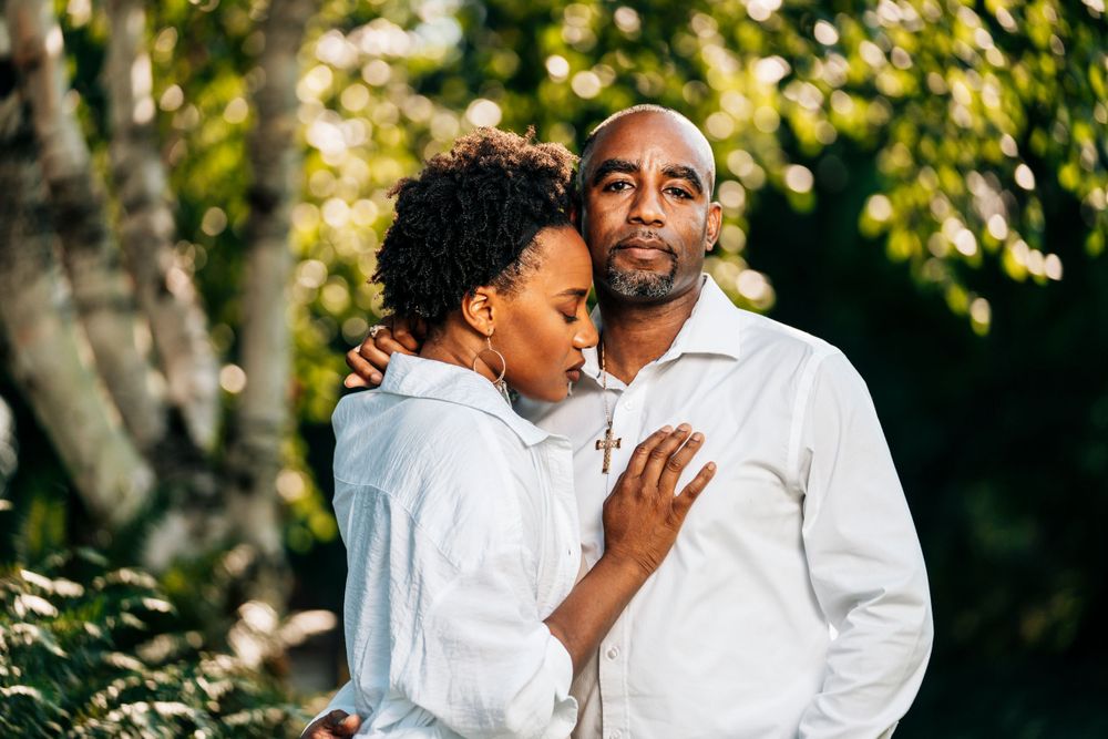 An intimate outdoor portrait showing connection between two people in white clothing.