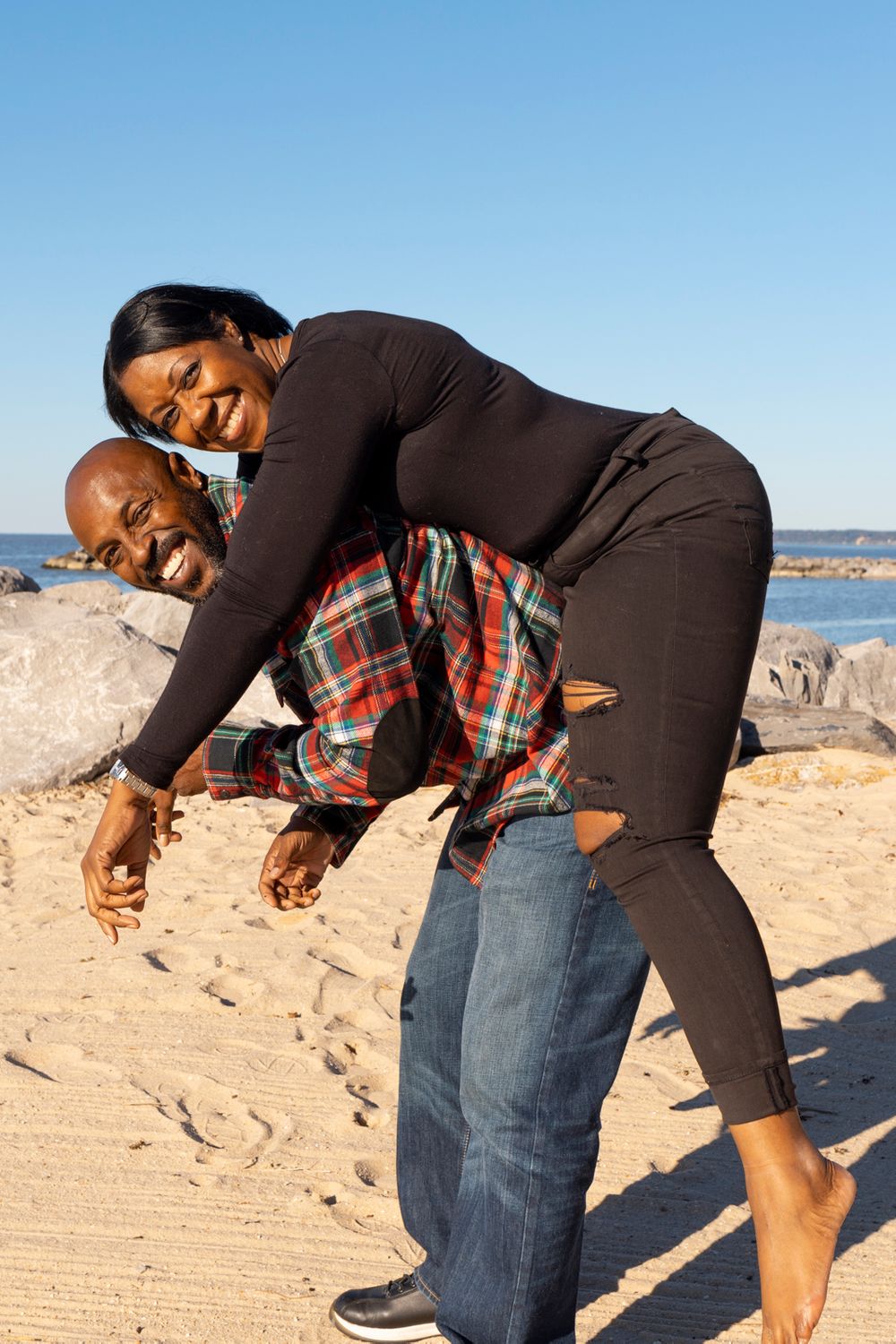 A couple doing a piggy back ride.