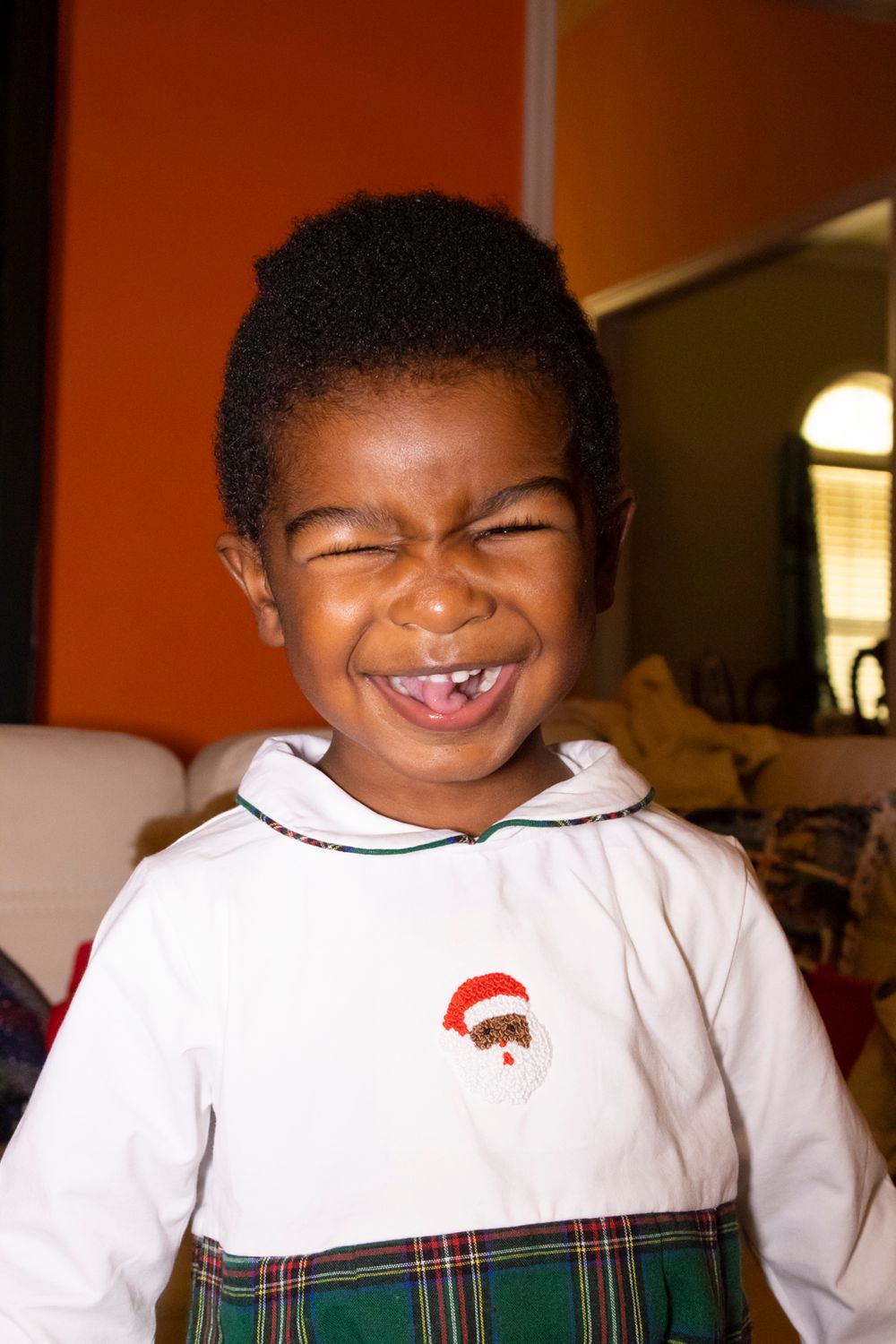 A child smiling with their eyes closed.