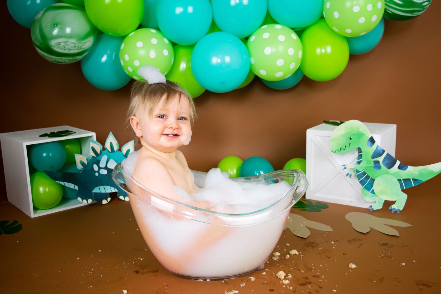 one year old boy smiling and splashing in the bath tub by cake smash photographer in doncaster.