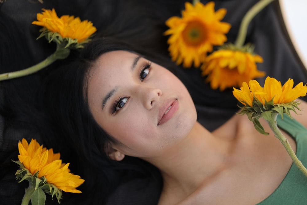 Girl Surrounded by Sunflowers Senior Photo Black Background
