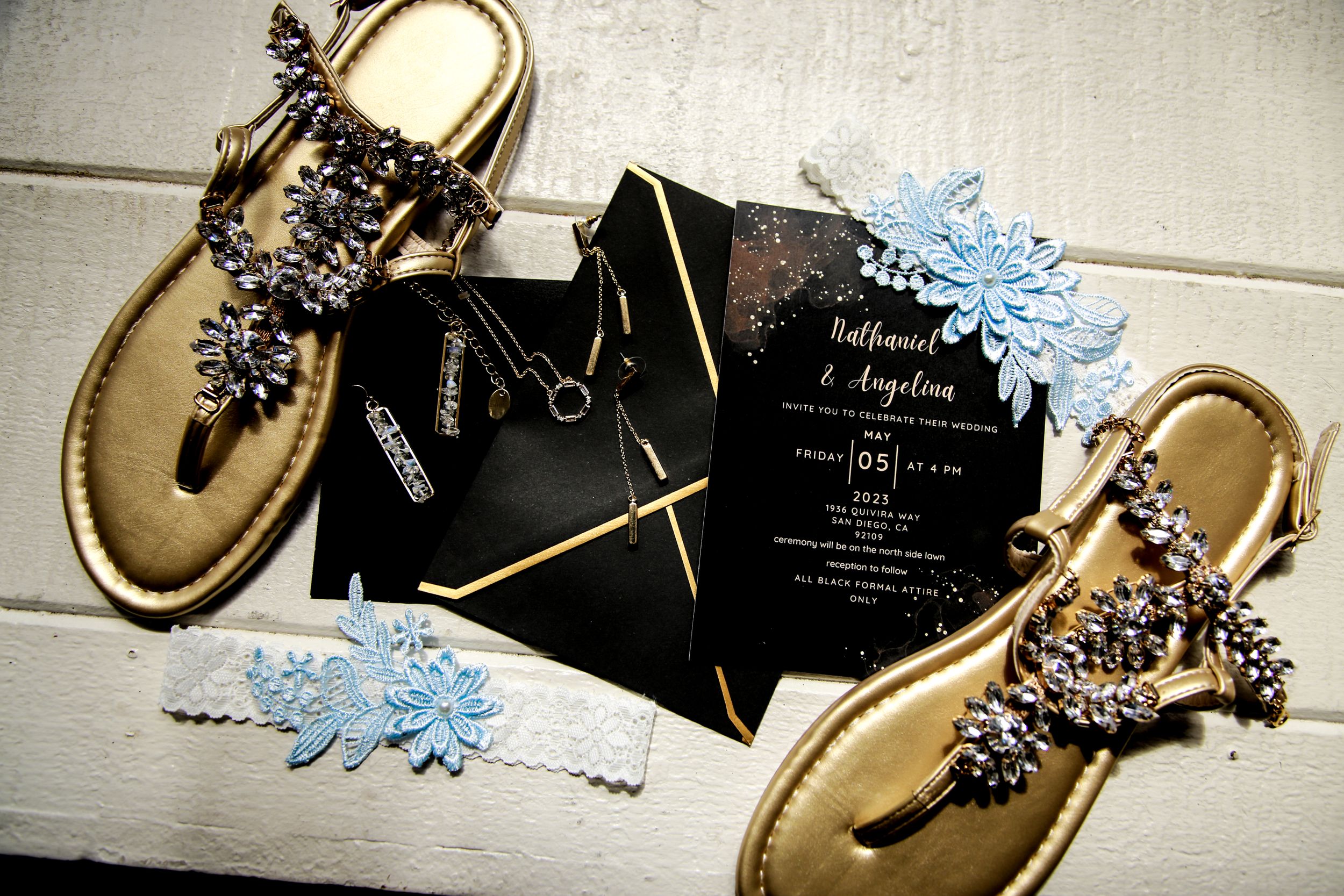 Wedding invitation suite with gold accents and delicate blue details.
