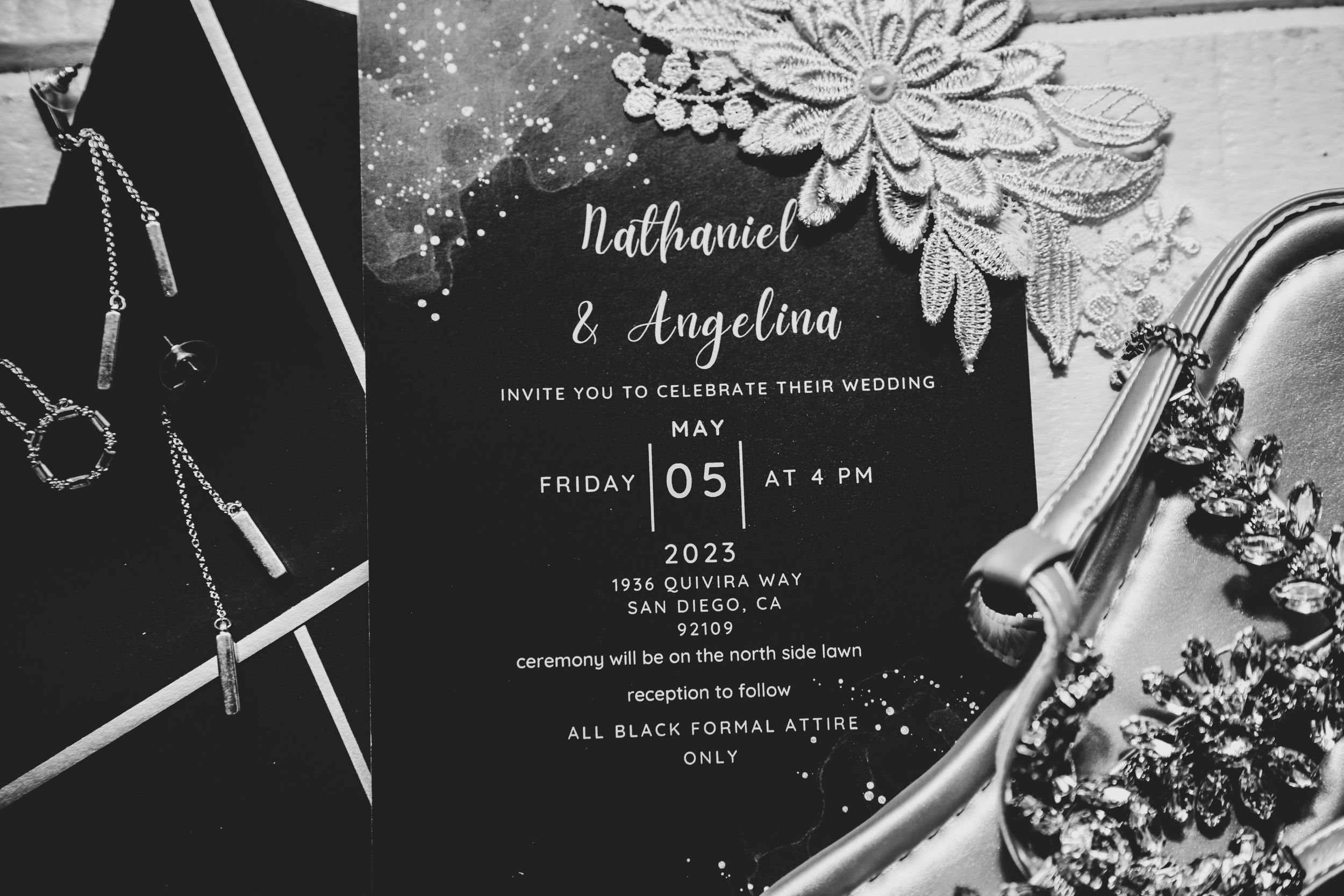 Black and white wedding invitations with floral designs and elegant typography.