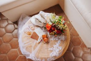 Overhead view of a decorated table with floral centerpiece and hexagonal tile floor.