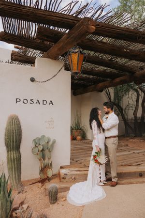 Rustic outdoor venue with adobe walls, wooden beams, and desert cacti at Posada resort.