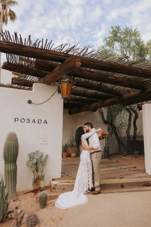 Wedding photography session at desert venue with cacti and rustic architecture.