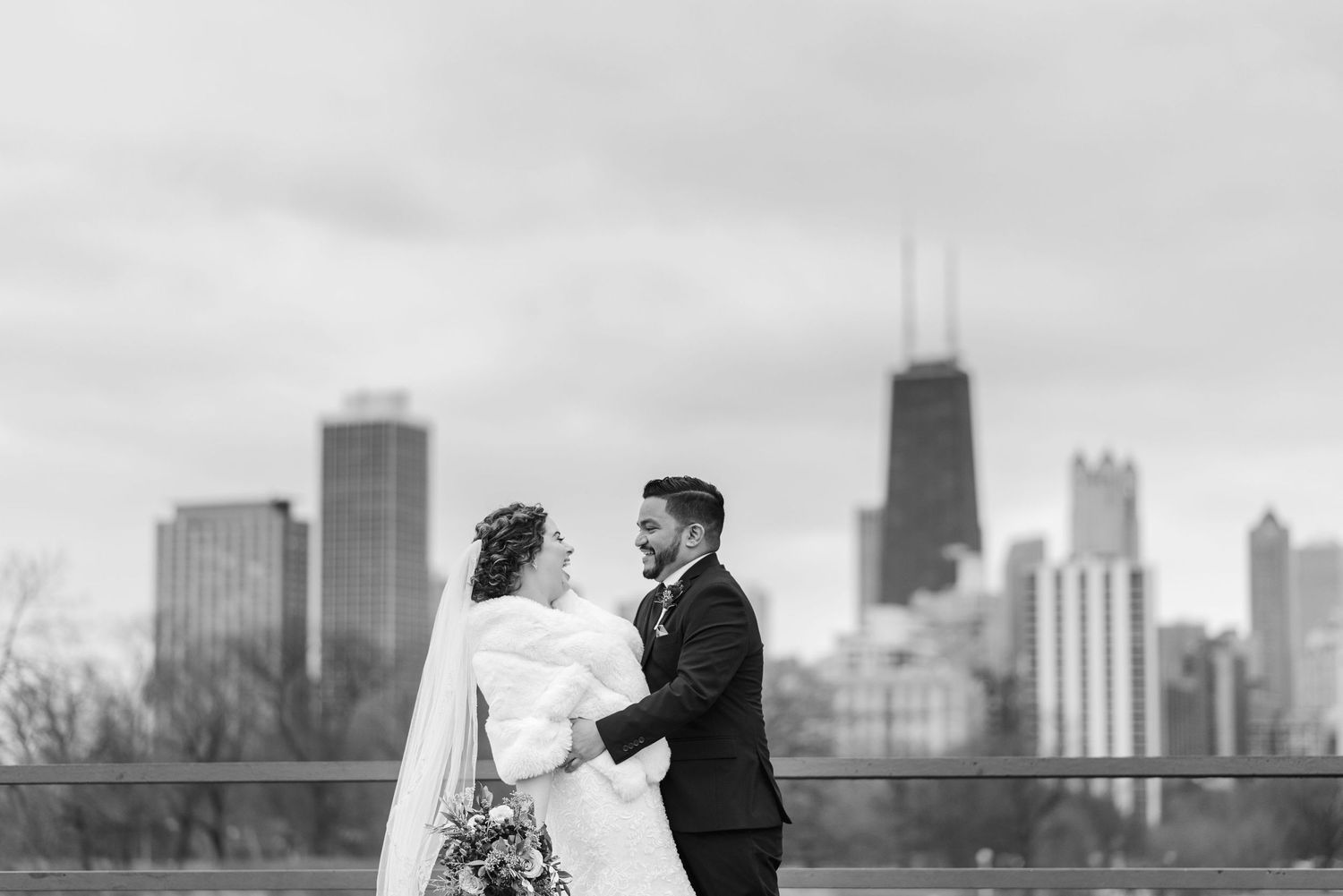 A romantic black and white cityscape wedding photo with the Chicago skyline in the background.
