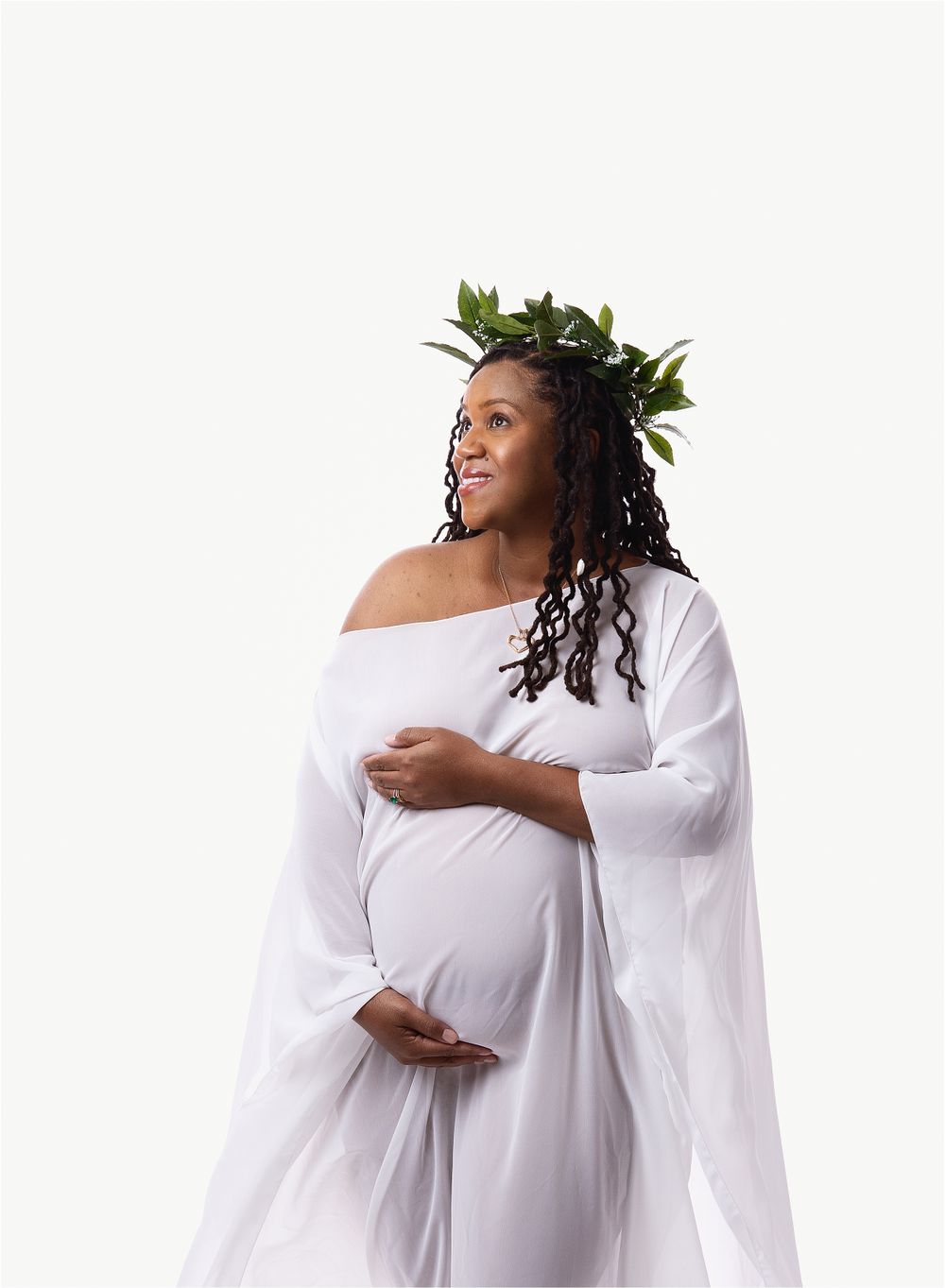 Modern fabric draped maternity portrait of black mom in white cape with grecian leaf halo by austin newborn photograper