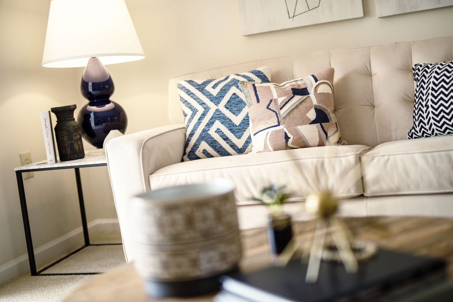 Modern living room decor with geometric throw pillows and contemporary accessories.