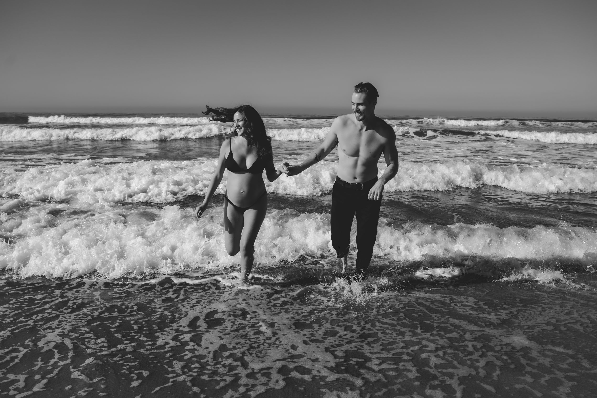 Celebrating a new addition to the family beachside: this couple chose to have their maternity photos taken while playing in the waves.