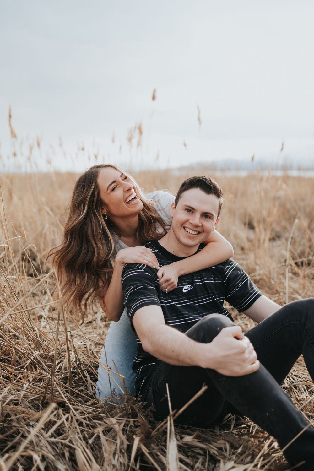 A couple laughs during a Utah engagement session, photographed by Salt Lake City wedding photographer.