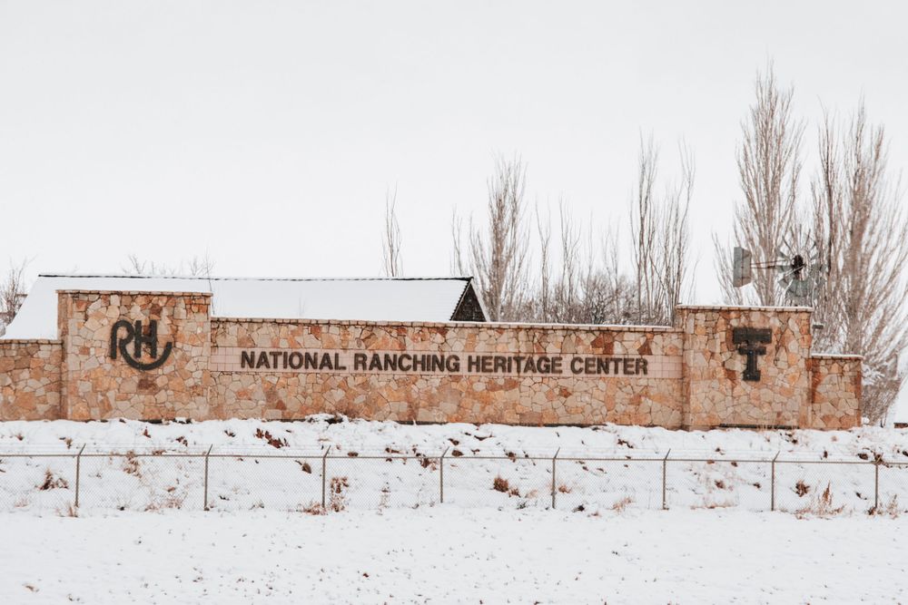 Snow-covered National Ranching Heritage Center building and grounds in winter.