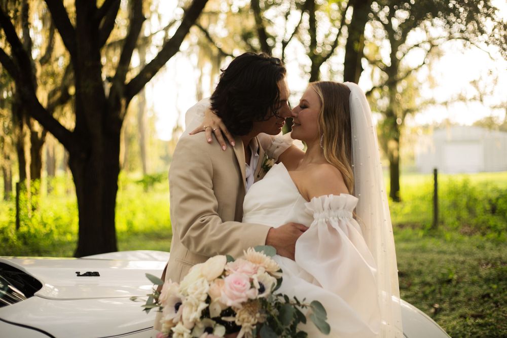 Sunset wedding portrait with Spanish moss trees in background.