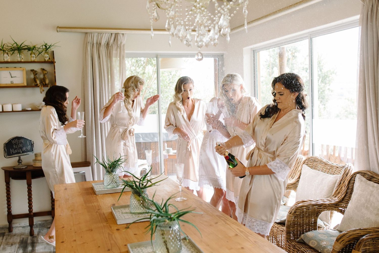 A bride and her bridesmaids popping the champagne in Copenhagen