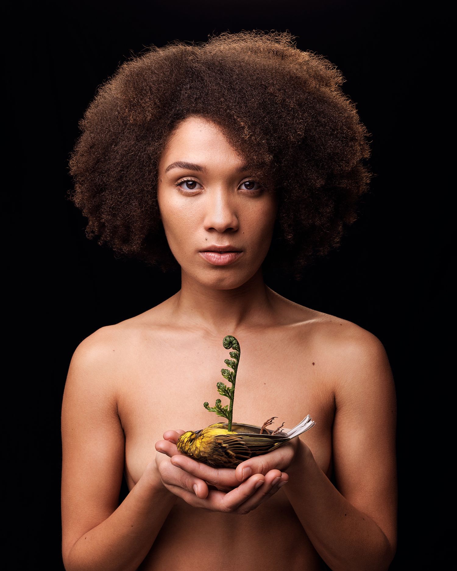 woman holding dead bird with fern growth