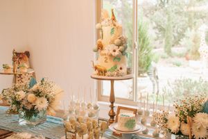 Light-filled venue decorated with white floral arrangements and elegant party decor.