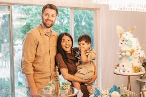 Safari themed celebration with elegant white tiered cake and balloon decorations.
