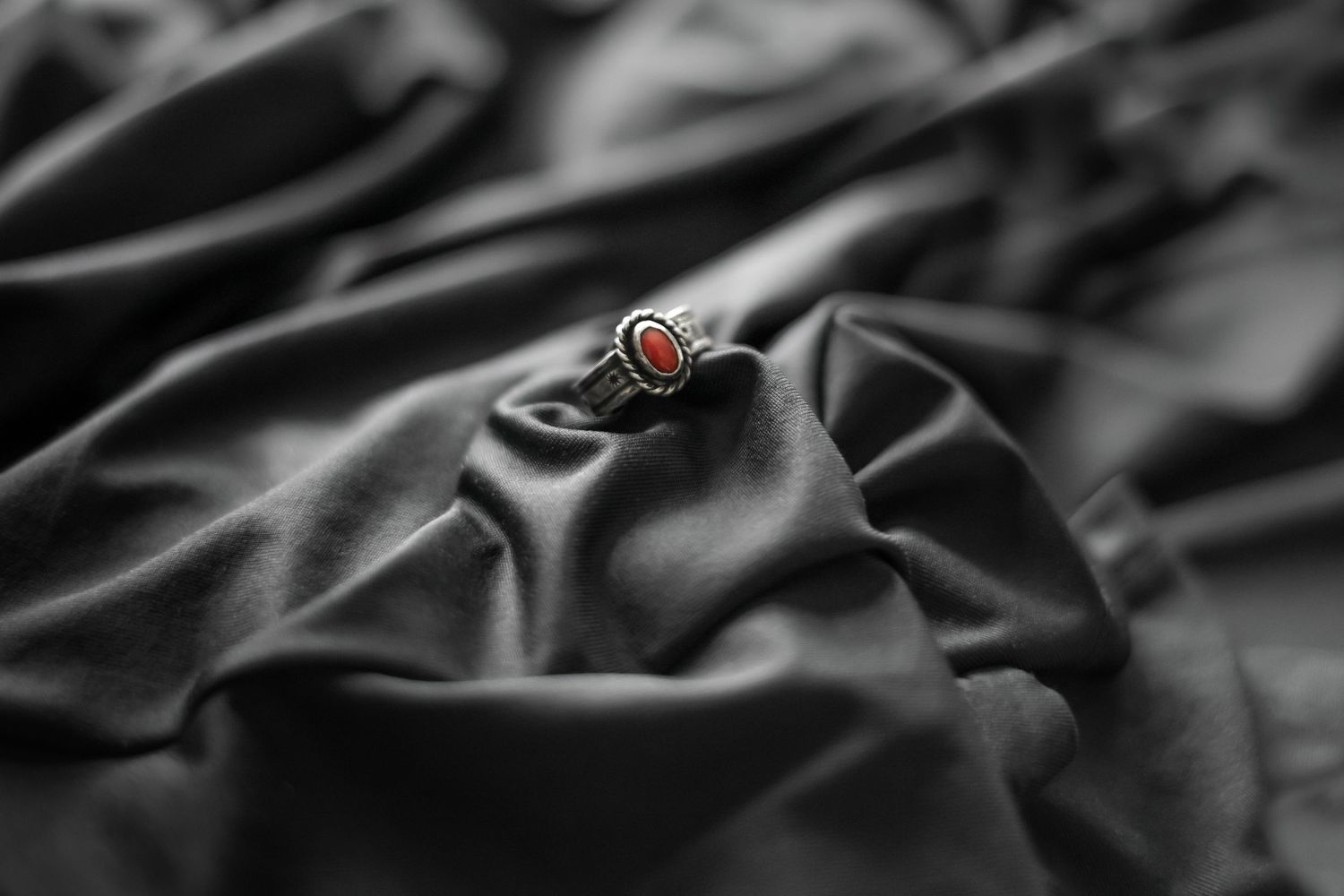 Red vintage ring in silk cloth product photography