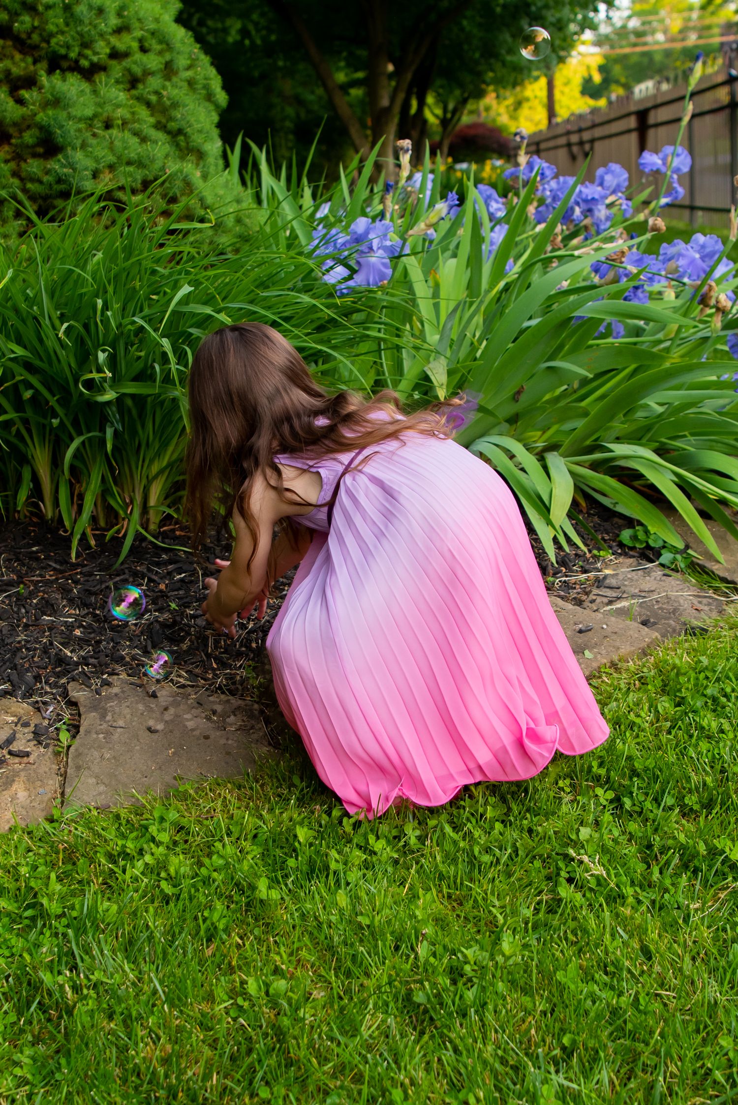 girl in pink dress in flower garden