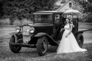 Black and white wedding photos with vintage cars creating a classic atmosphere.