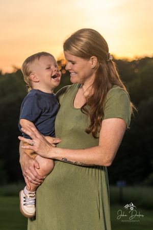 A joyful moment captured between parent and child during golden hour sunset.