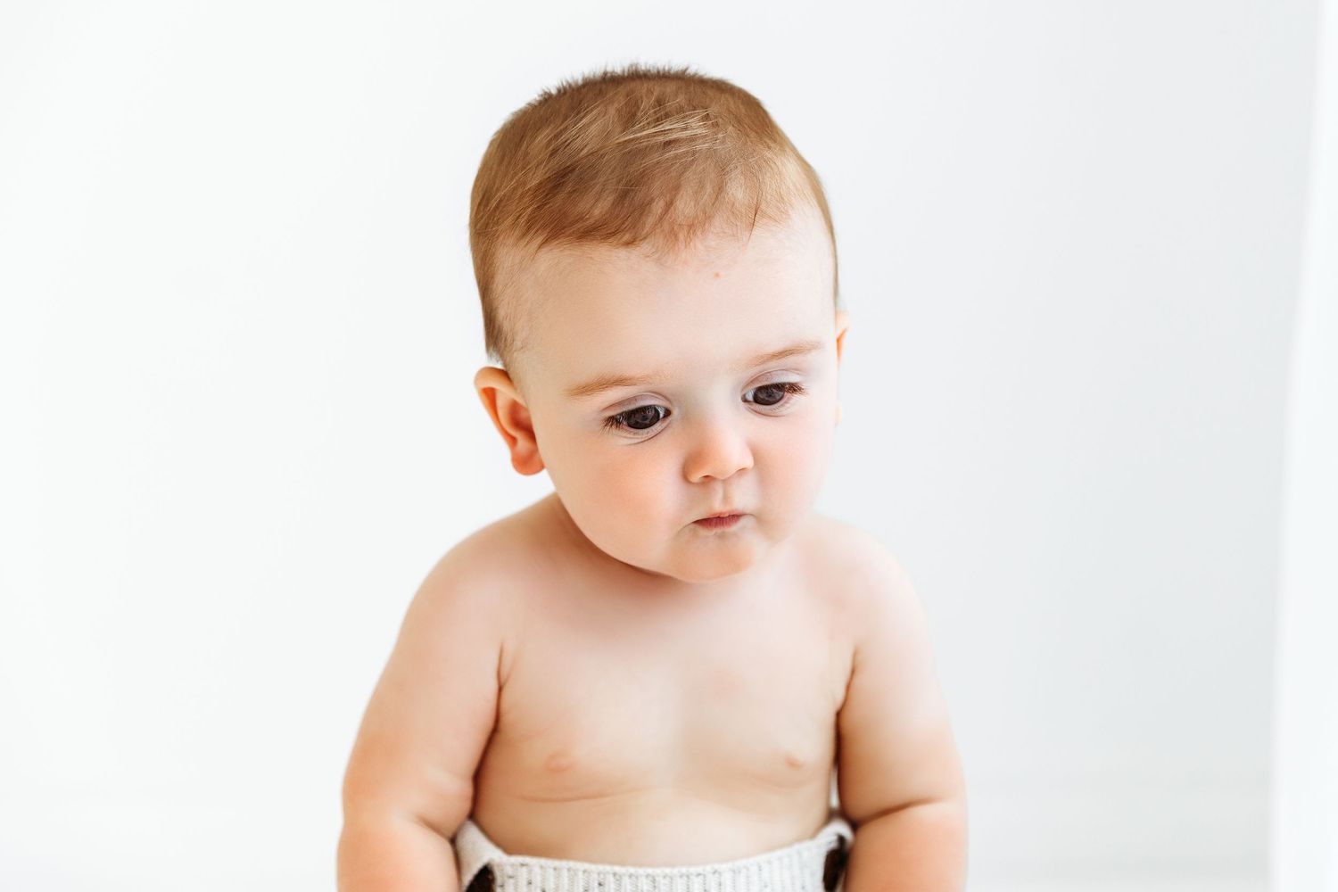 Baby boy looking puzzled or sad