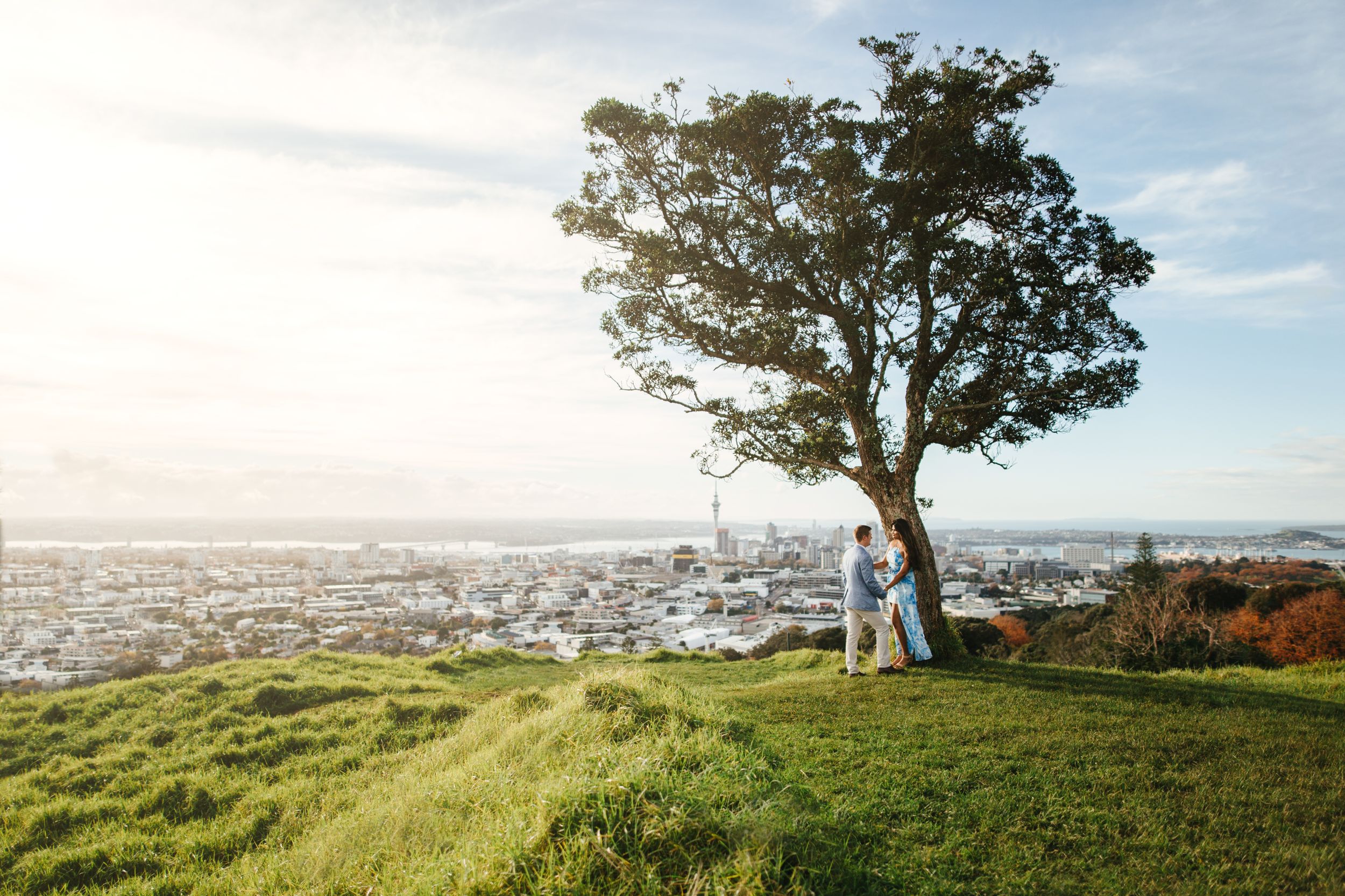 Couple posing on top of Mount Eden during sunset, Auckland