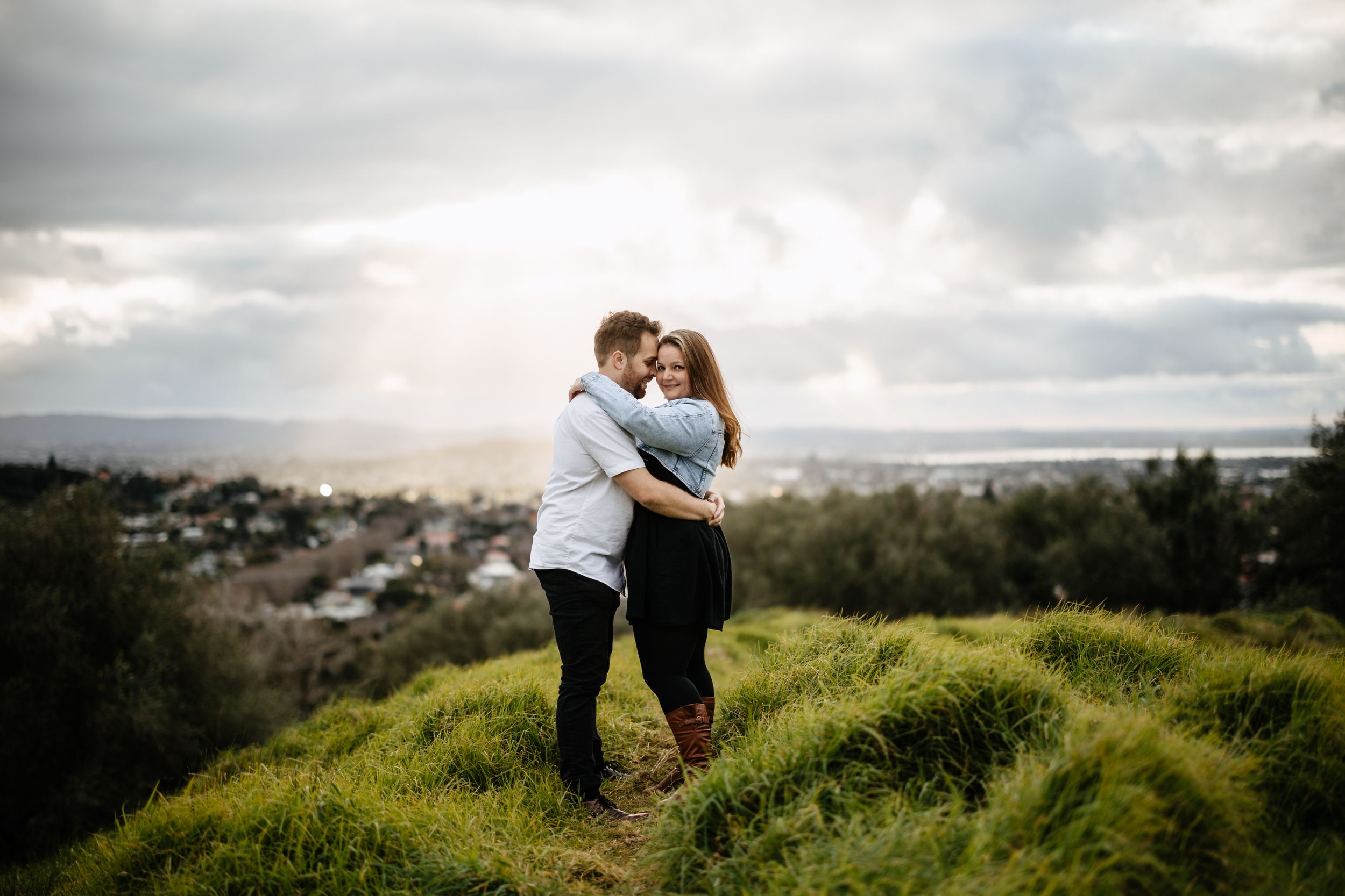 Couple posing on top of One Tree Hill Auckland