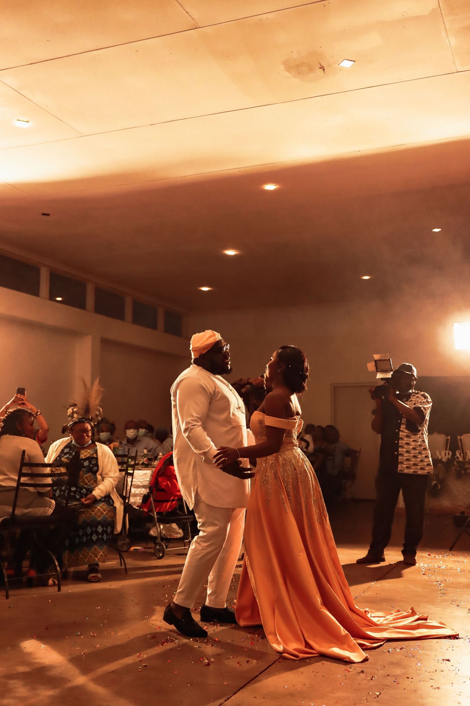 Couple sharing a romantic dance moment at their wedding reception in formal attire.