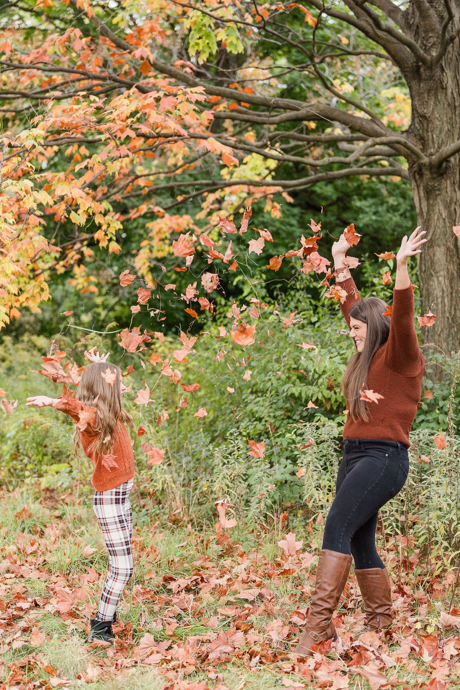 aunt and niece photoshoot at busse woods. standing in a field posing taken by a milwaukee wedding photographer