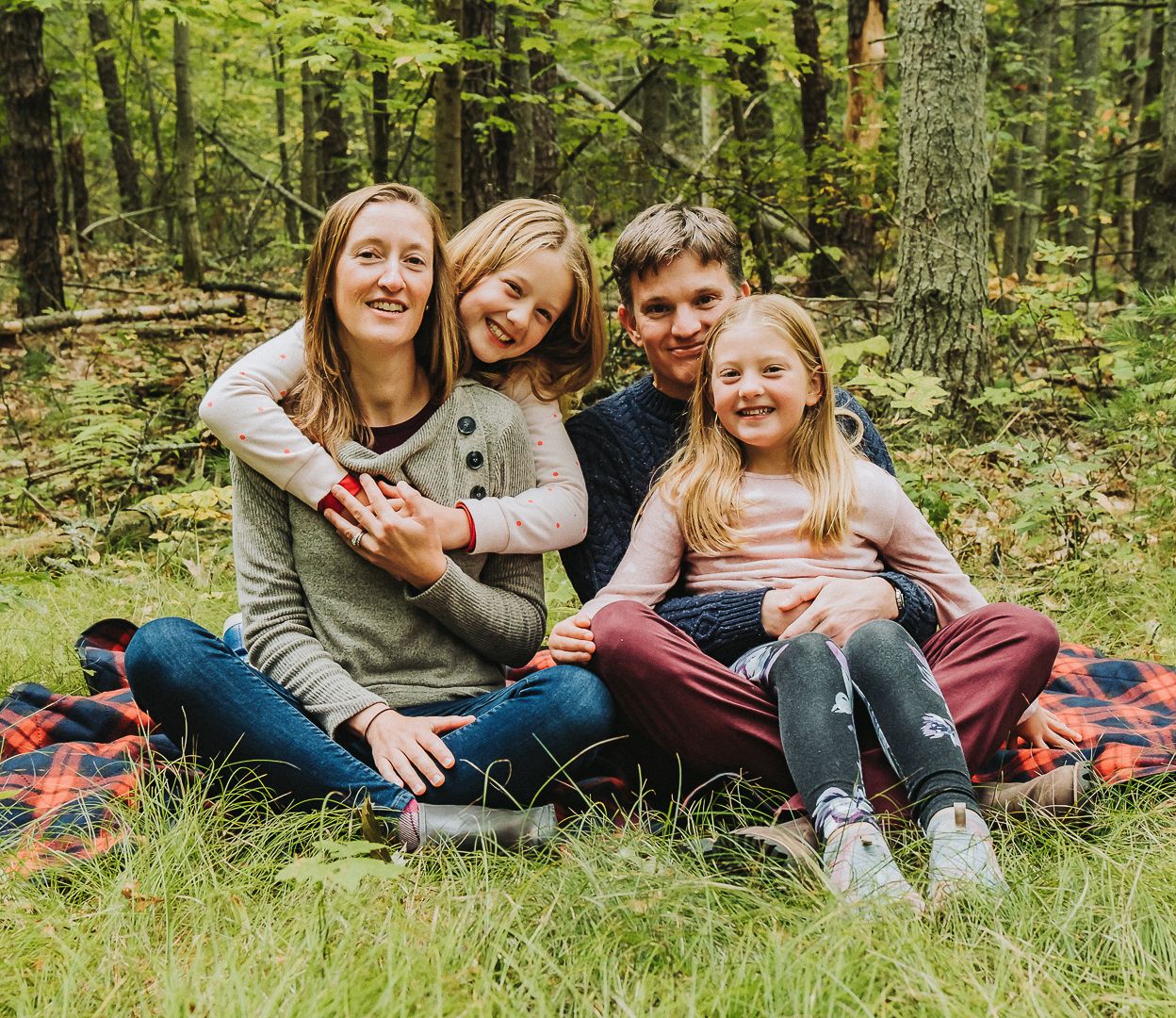 A family poses together during a fall family photo session in Brunswick, Maine.