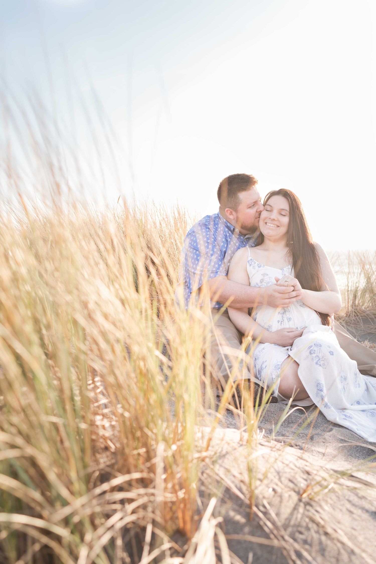 Couple getting maternity photos done on the beach along the Southern Oregon Coast.