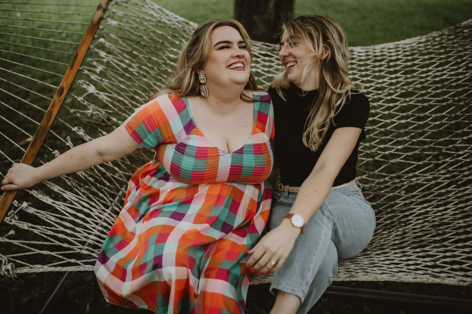 two girls on a hammock smiling