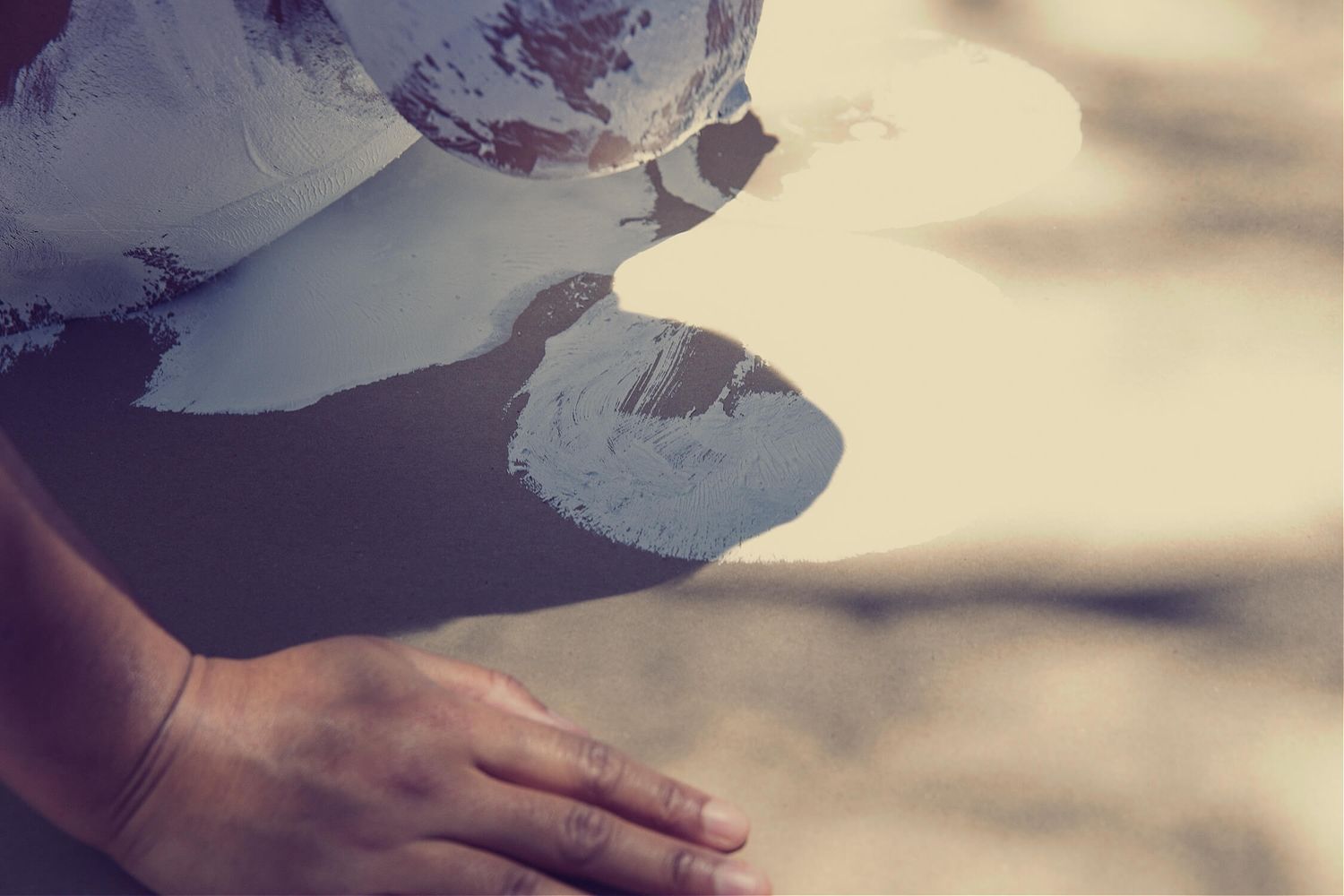Artistic photograph showing hand placement with soft shadows and light effects.