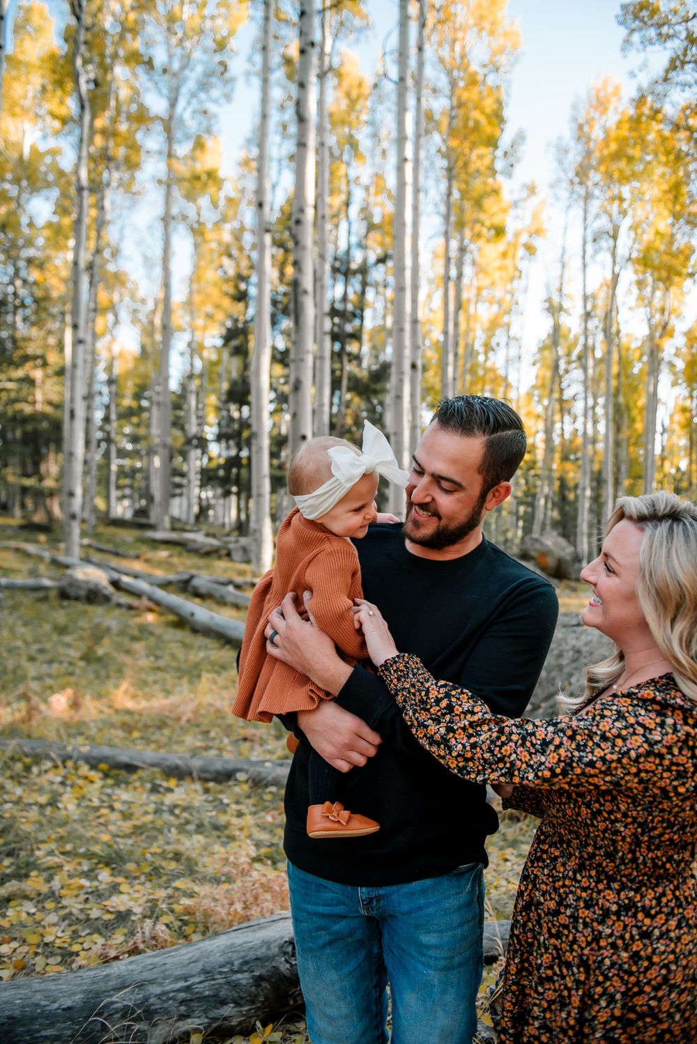 Couple shares tender moment in an aspen grove with golden fall foliage.