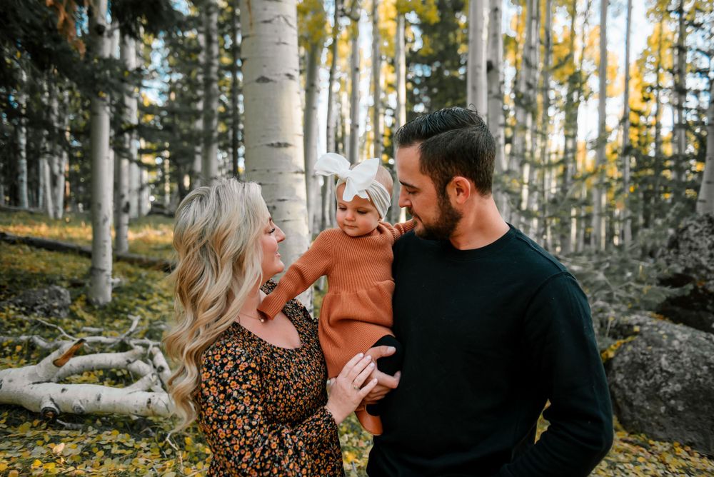 Casual family portraits taken in a sunlit aspen grove during autumn.