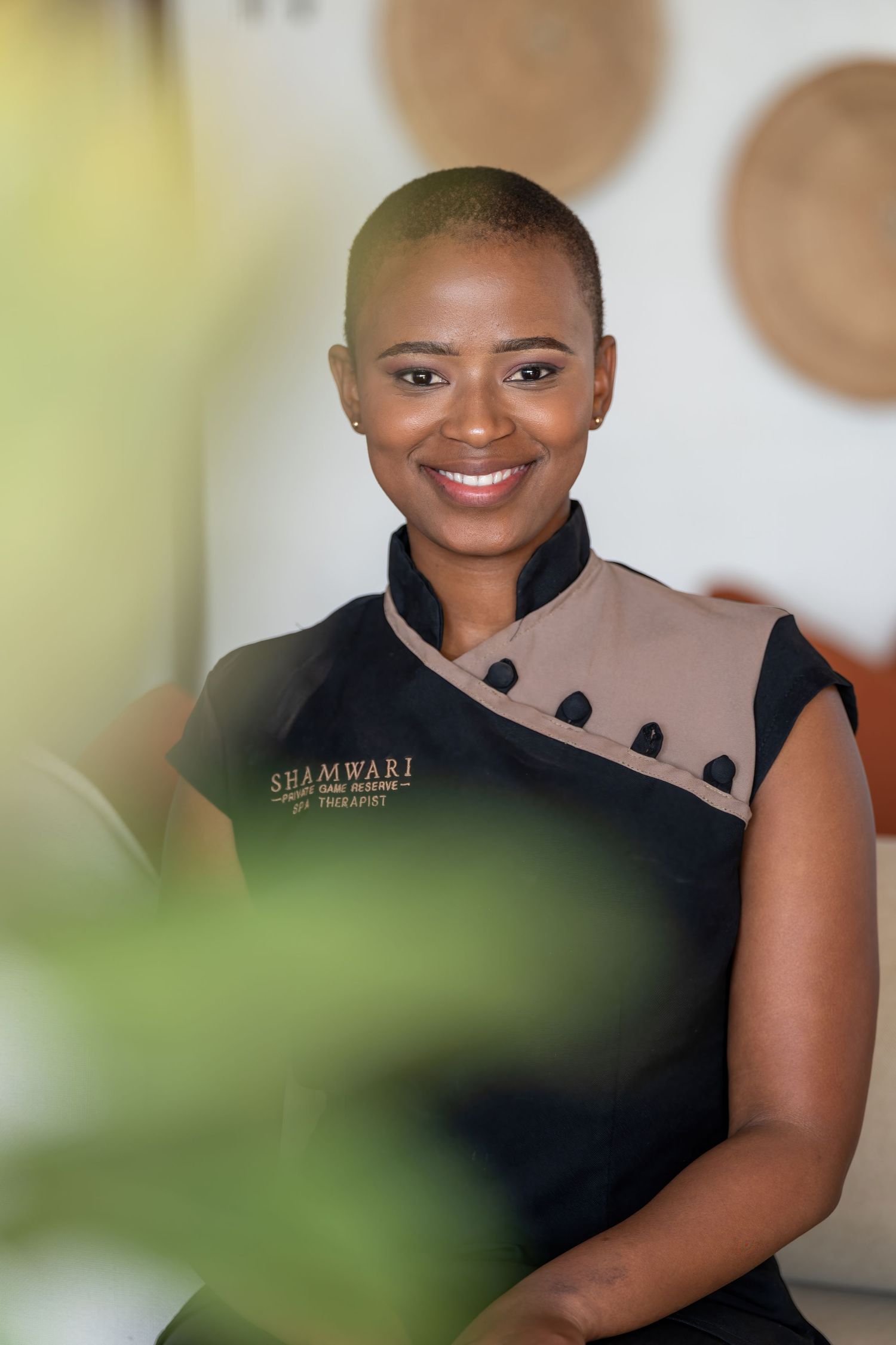 Restaurant team member wearing black uniform with elegant design elements.