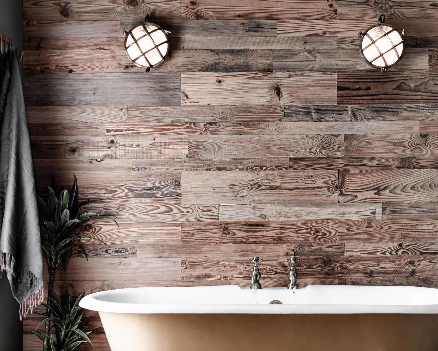 Stylish rustic bath with green towel and plant to side, luxurious boutique hotel photography