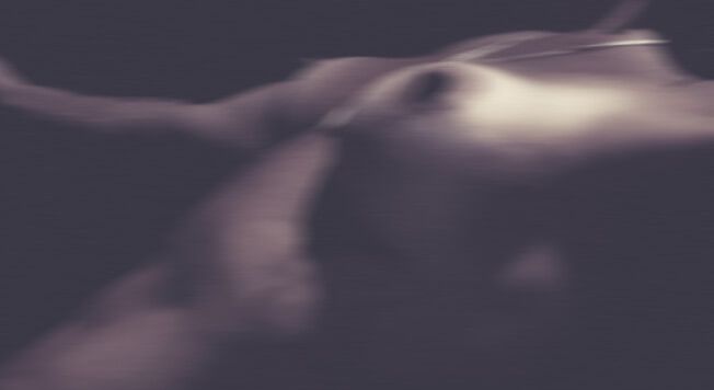 Abstract blurred curved shapes in dark purple and gray tones creating a dreamy atmospheric effect.