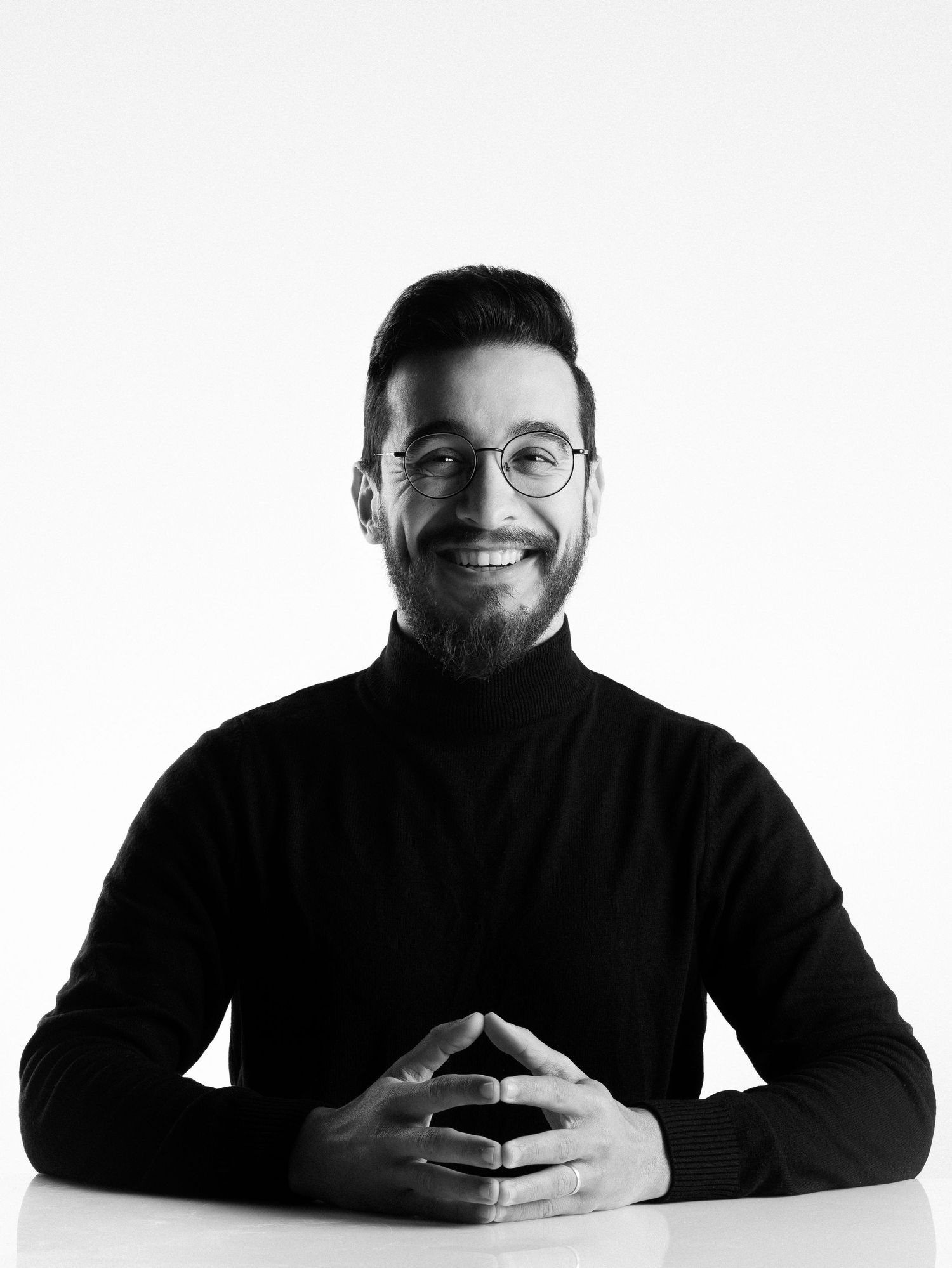 Black and white portrait series showing expressive poses against white background.