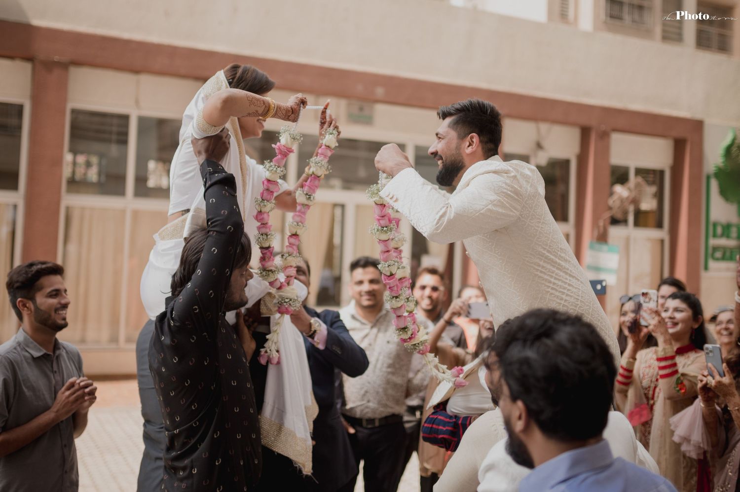 Guests celebrate with confetti and dancing during indoor wedding reception.