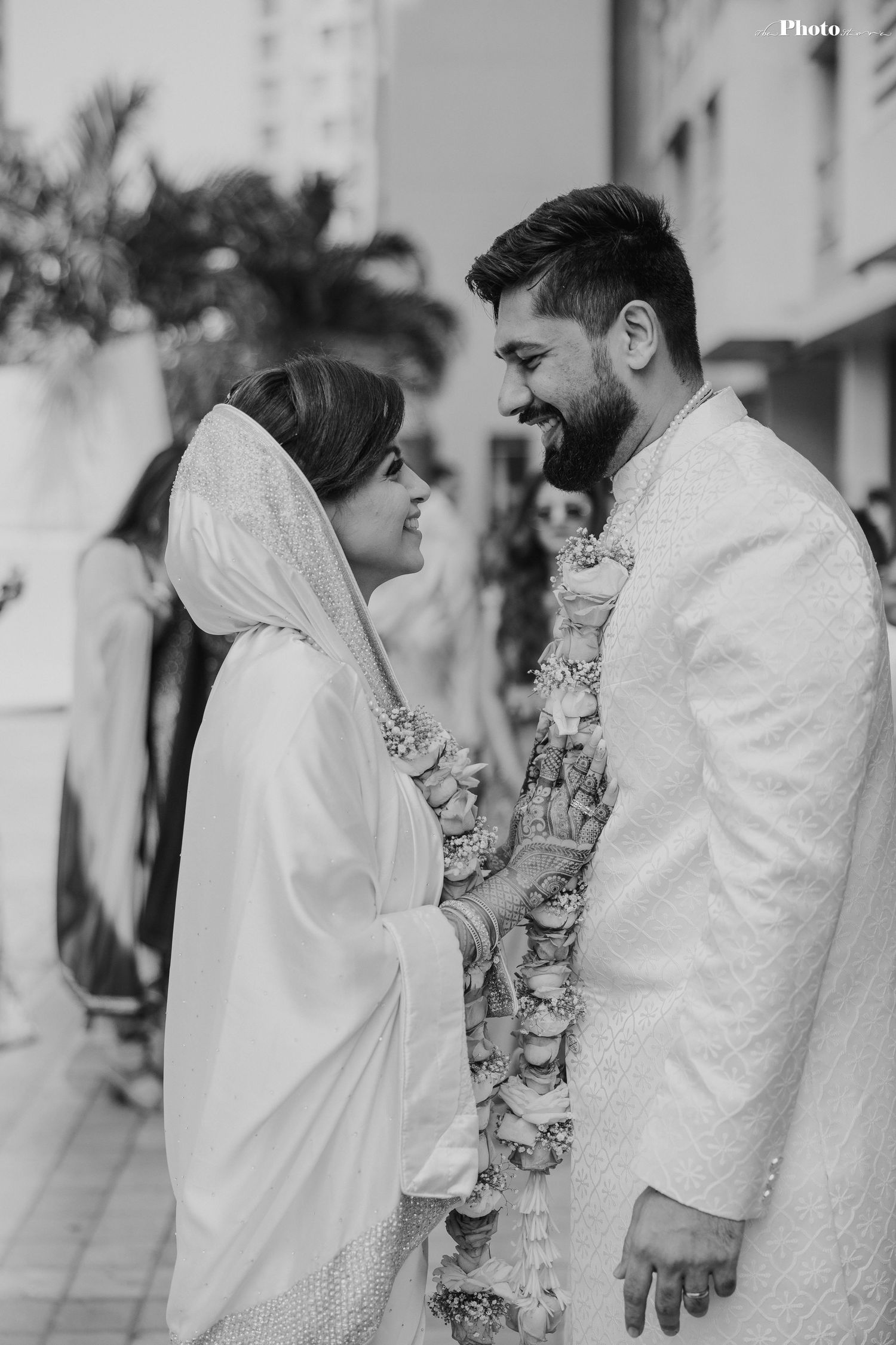 Black and white photo of a traditional wedding ceremony with elegant white attire.