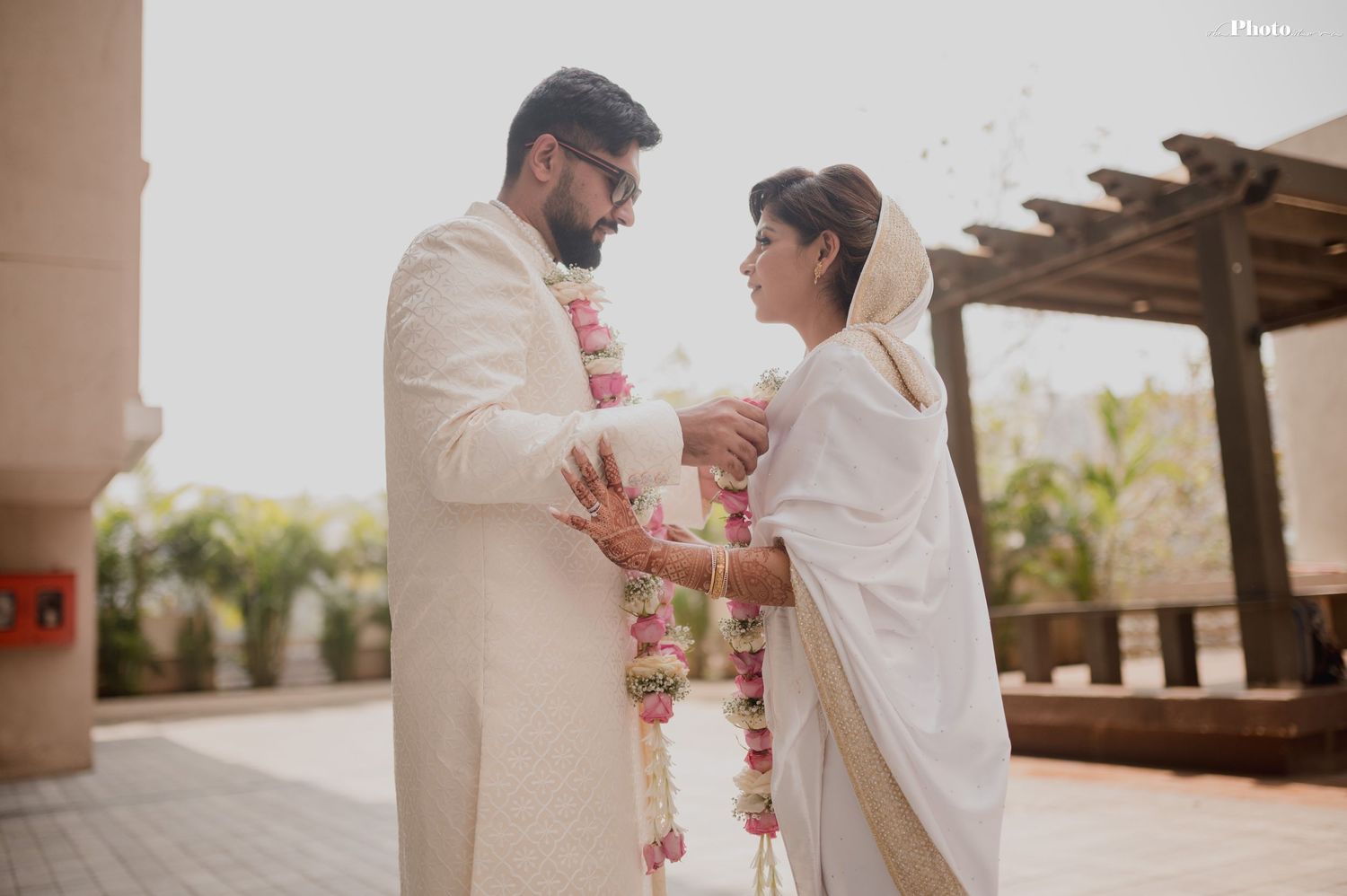 Romantic wedding ceremony moments captured under an outdoor pergola.